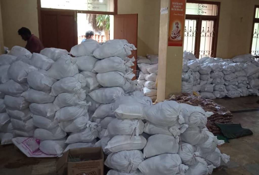 Stacks of white sacks piled indoors in a storage area.