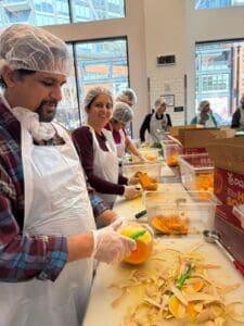 Volunteers peeling squash in community kitchen